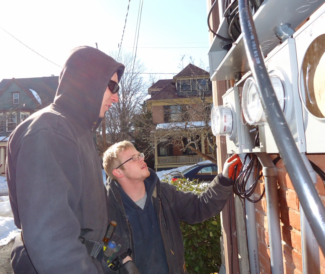 electrician inspecting wiring panel